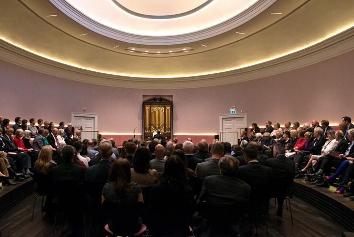 An audience enjoying a performance in the oval concert hall