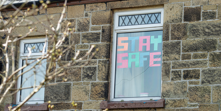 House with stay safe message - Caymia via Getty Images