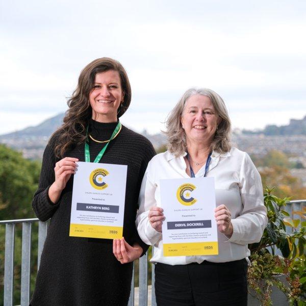 Kathryn Berg and Dervell Dockrell with their EDS UK Community Champion Award Certificates