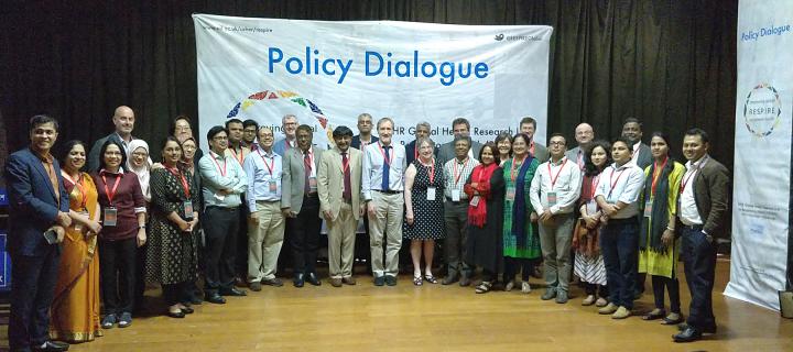 RESPIRE group pictured at Policy Dialogue event in Bangladesh in front of banner