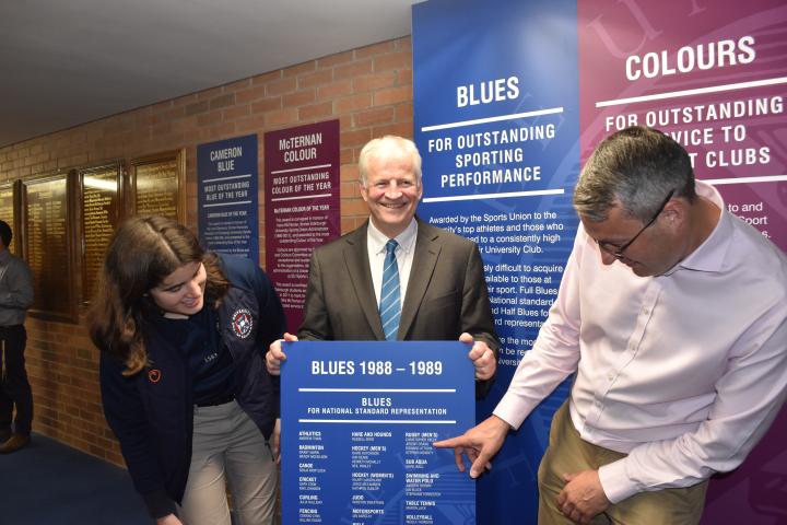 Jeremy Crang posing with 1988-89 Blues board with Mark Monro and Heather Gault 