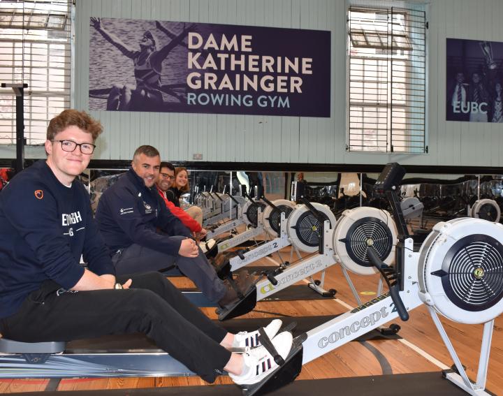 athletes and staff on ergs
