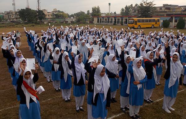 Group of school children holding up signs during World Pneumonia Day