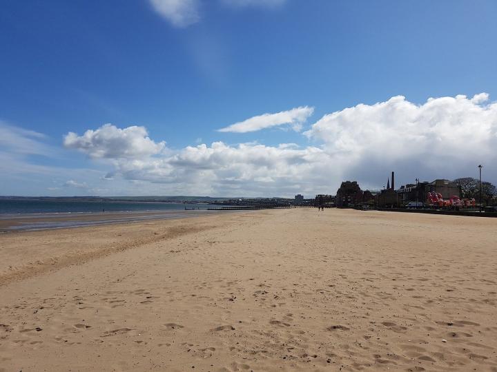 Photograph of Portobello beach, to the left is the River Forth and to the right of the image are the houses along the promenade