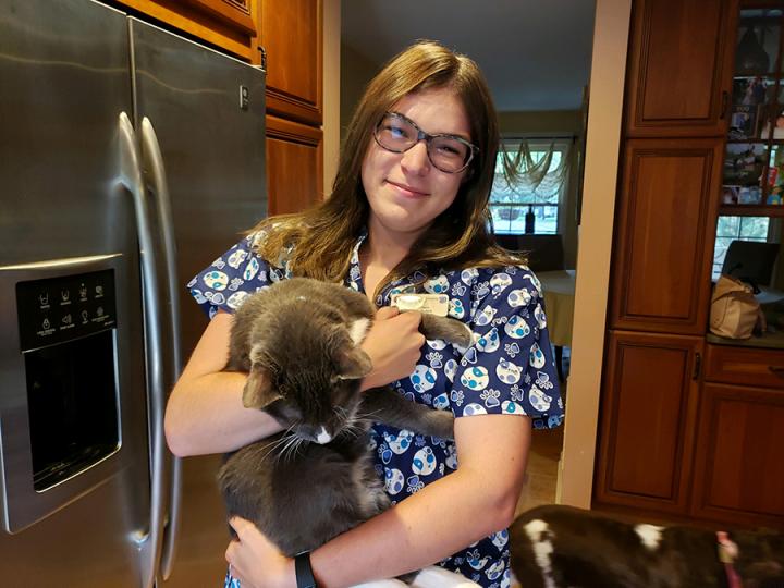 Emily Rabon posing, holding her pet cat