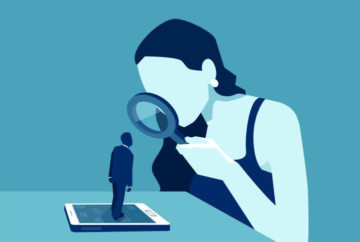 Vector of a woman with magnifying glass looking at a man standing on a modern gadget device, smartphone or tablet