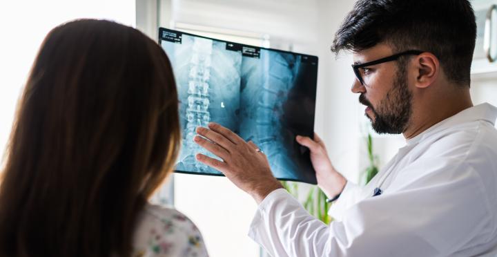 Two doctors looking at x-ray of spine