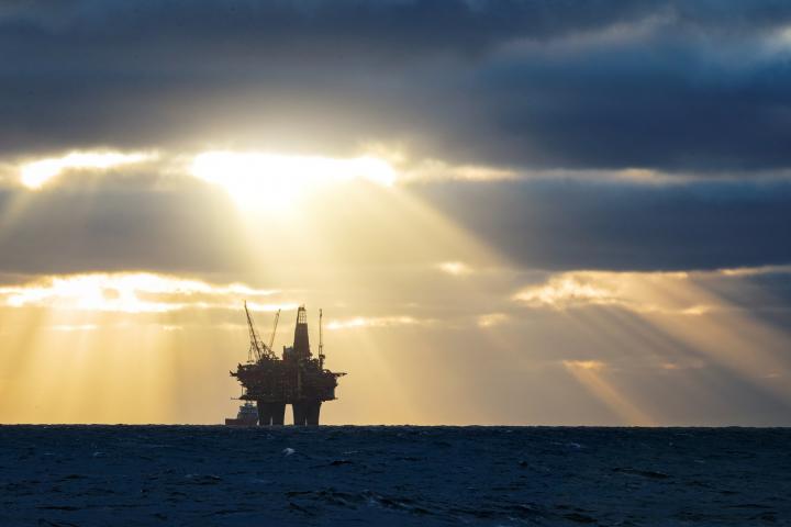 Shaft of sunlight illuminates oil rig in North Sea
