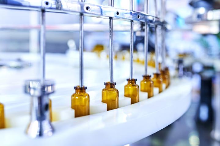 Image of brown medicine glass bottles on a production line