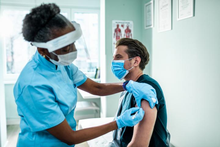 Stock image of person receiving a Covid-19 vaccine