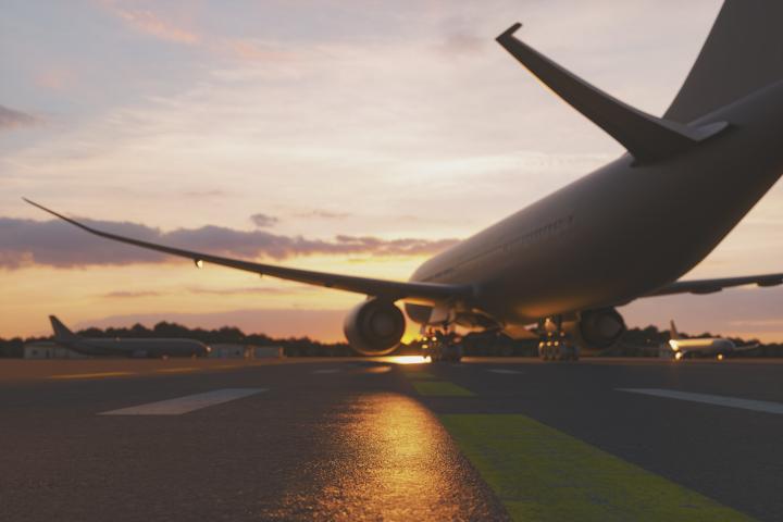 Image of grounded aeroplanes on a runway at sunset