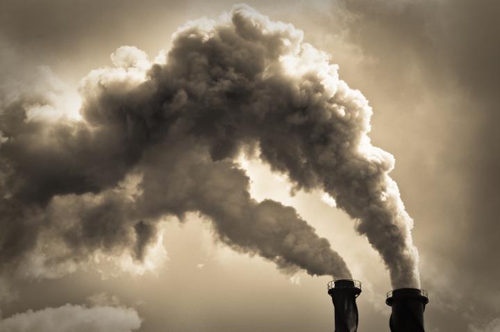 Stock image of two industrial chimneys