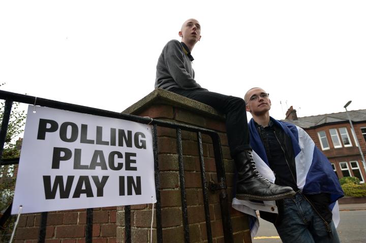 Two young people voting for the first time outside a polling place in the Scottish Independence Referendum 