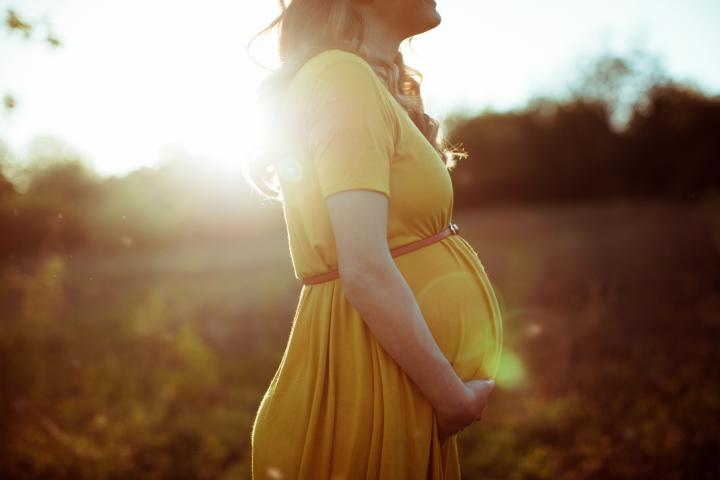 Pregnant woman soaks up the sun's rays