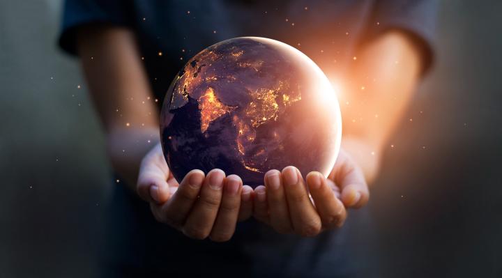 Stock image of a person holding the Earth