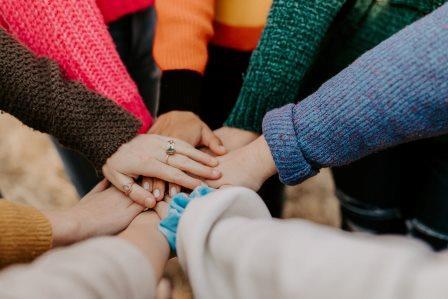 team hands piled together