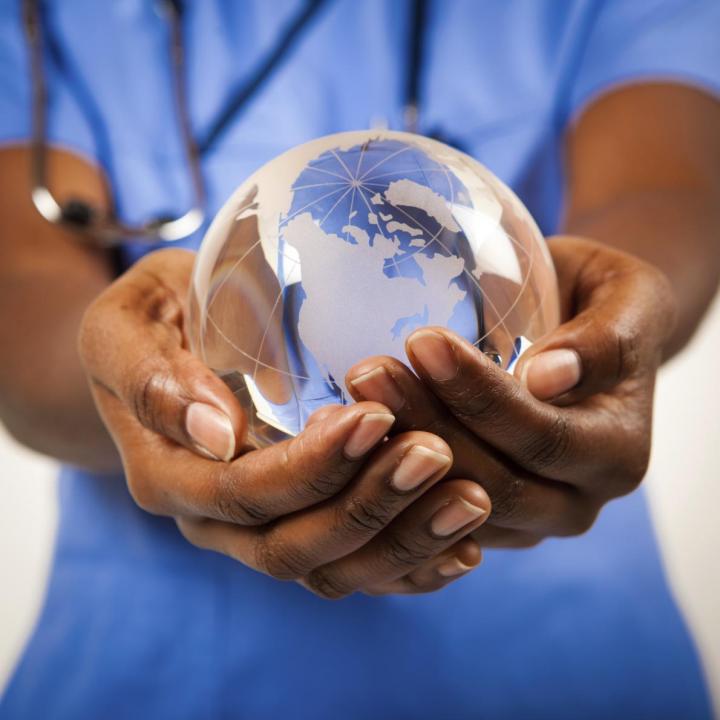 Doctor holding glass globe