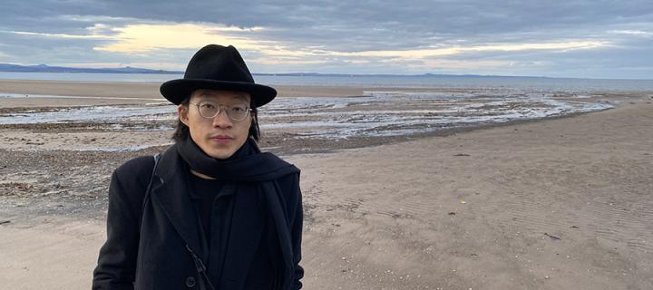 Photo of Hoi Lun Law standing on a beach