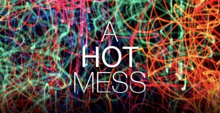 A picture showing the words "a hot mess" over a background of mixed blurry neon lights.