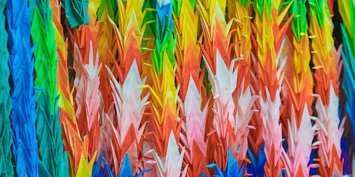 a series of colourful paper cranes