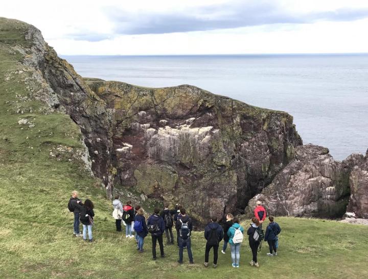 Students standing by the ocean on a day trip to St Abbs Marine Station