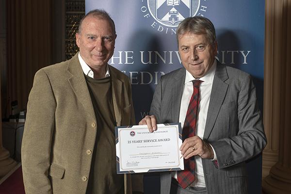 Photograph of Professor Chris Williams receiving 25 years service award