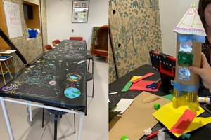 Two side by side photos - a black table covering covered in space-themed drawings, and a space rocket made from craft supplies