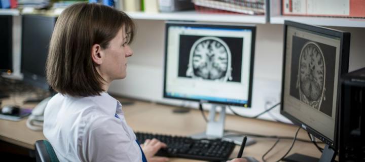 Woman looking at a brain on a screen