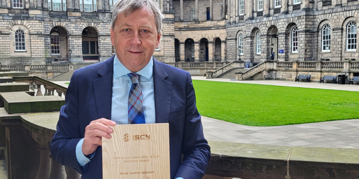 Principal and Vice-Chancellor, Professor Peter Mathieson, holding trophy for ISCN award 2022