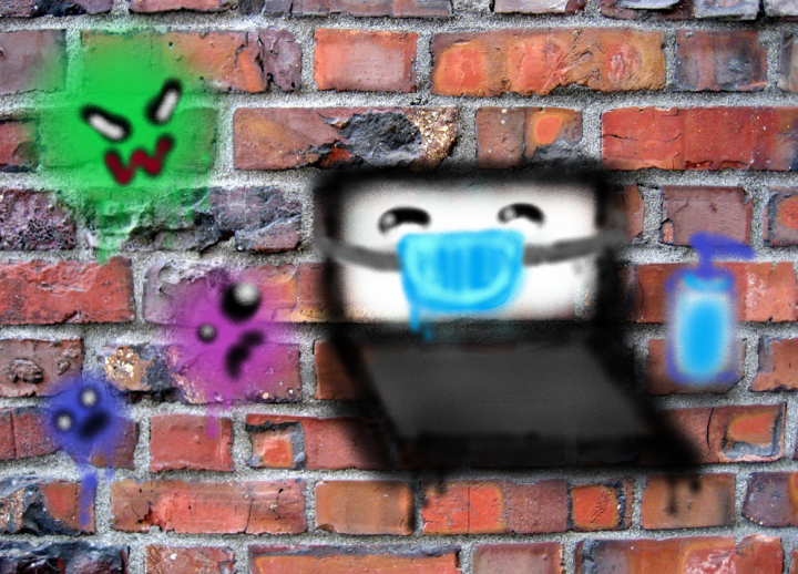 Laptop wearing mask spray painted onto brick wall