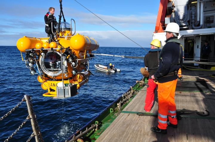 Researchers with deep-ocean science equipment.