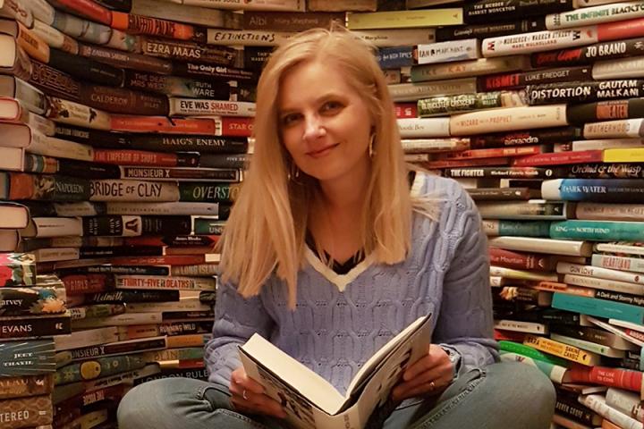 Photo of June surrounded by books