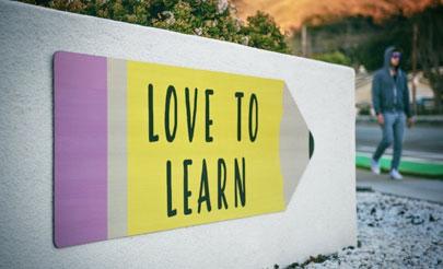 sign on building that reads 'love to learn'
