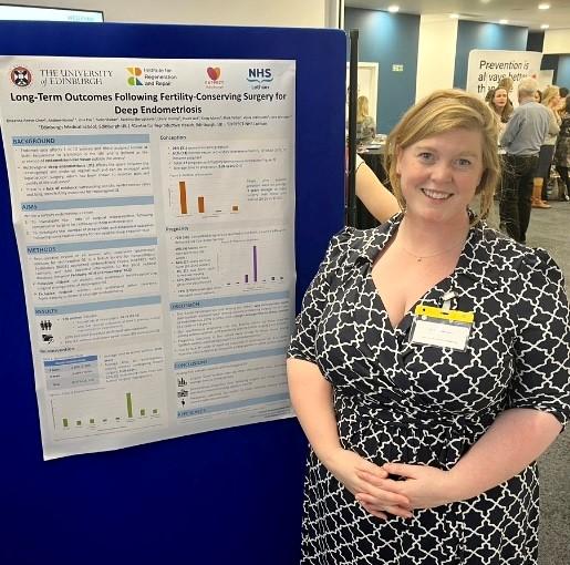 Lucy Whitaker standing beside her poster presentation
