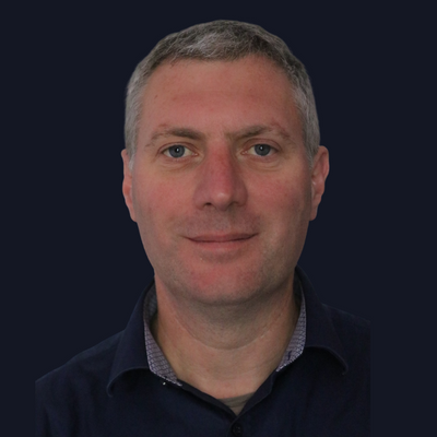 Dr Marcus Harrison profile photo against dark navy background