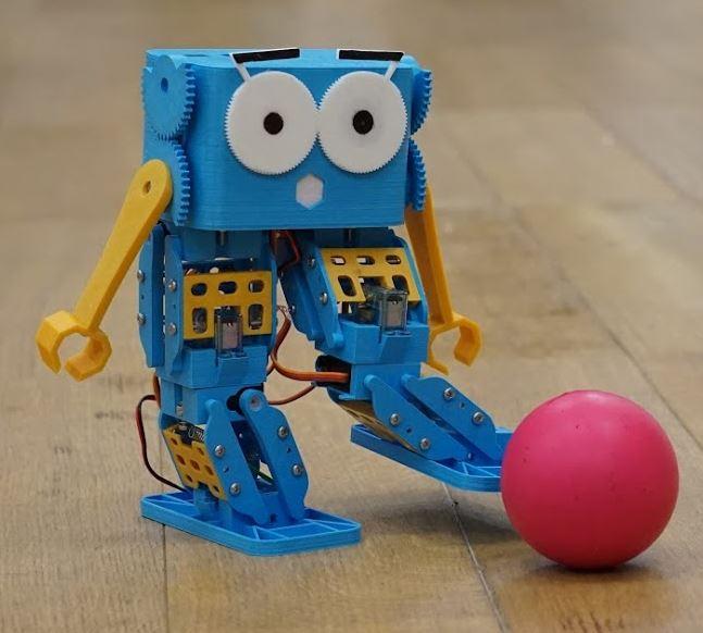 Marty the little blue robot kicking a ball