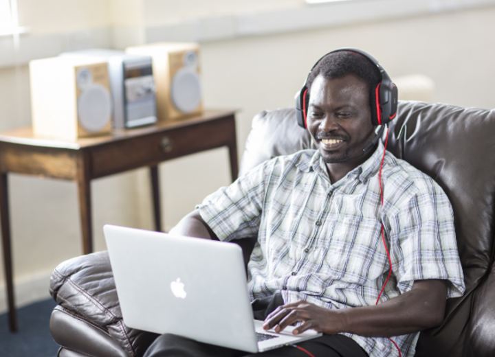 online student studying at home with headphones on