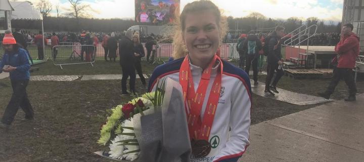 Picture of Megan Keith with gold medals from her cross country european victory