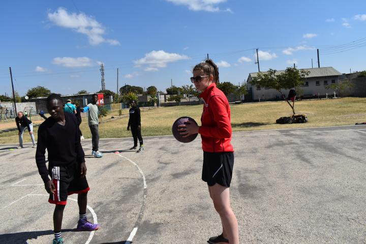 Student teaching basketball in Zambia