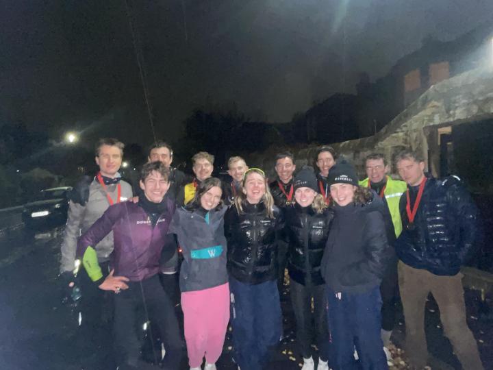 Group of cyclists pictured at night celebrating