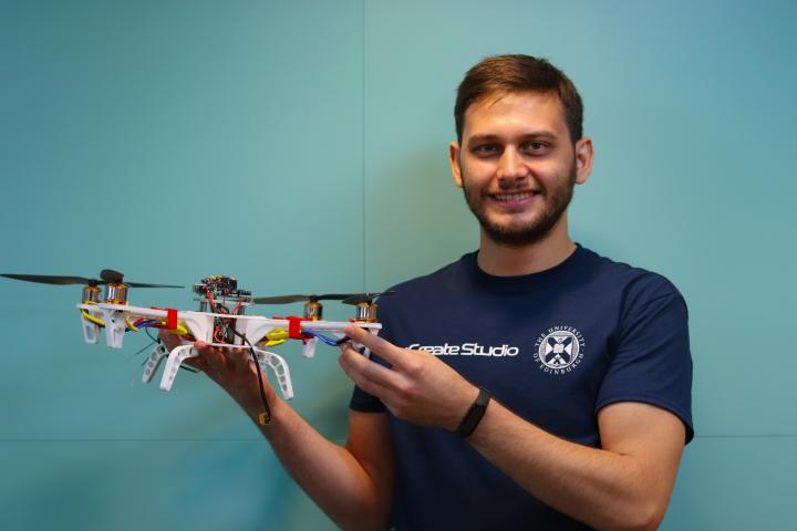Murat Çelik, Student Technician, holding a 3D-printed drone