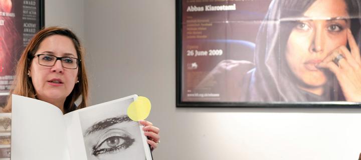 Photo of Nacim Pak Shiraz with a film poster