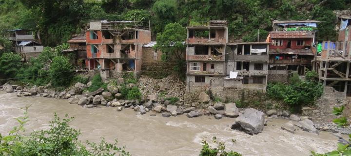 Run-down housing along a muddy river in Nepal