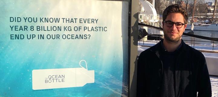 Nick Doman next to an advert for Ocean Bottle