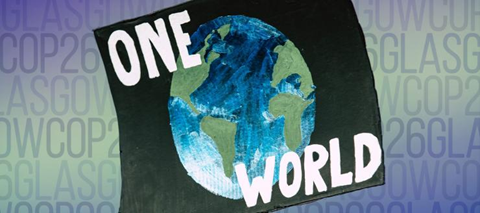 Banner for the UN Climate Change Conference (COP26). A black flag with an image of earth with the text "One" above the image of the earth and "World" below it. The background is different shades of blue and green with the text "GlasgowCOP26" repeated.
