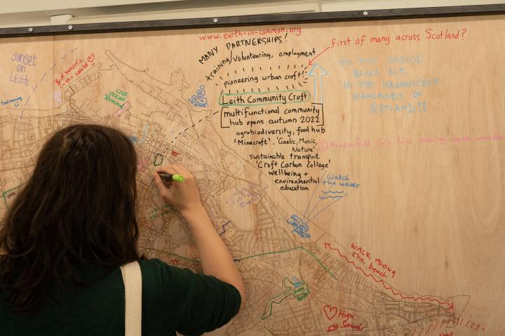Image shows participant writing on an interactive map of Edinburgh. Credit: India Hunkin