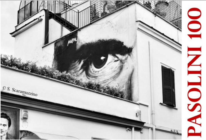 Street art of a large eye overlooking a street
