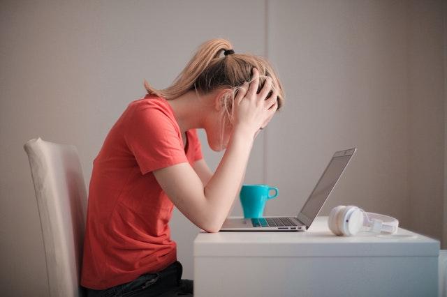 Online student stressed at desk