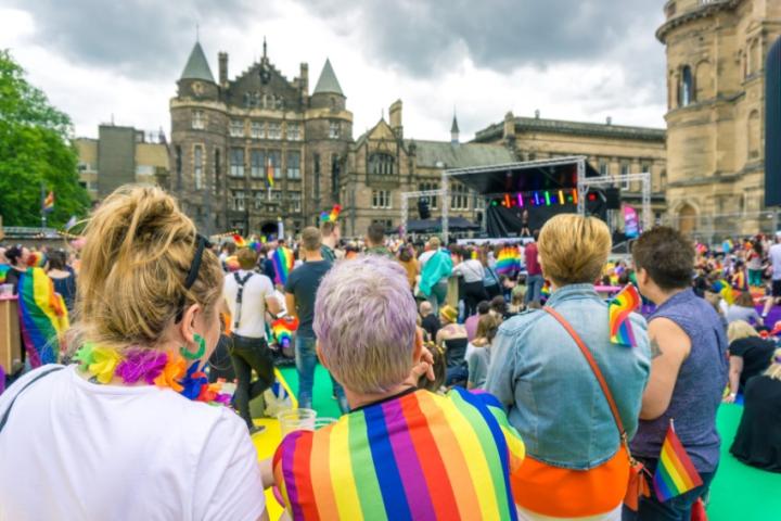 Audience members wearing and carrying pride flags at the Edinburgh Pride festival at Bristo Square in 2019