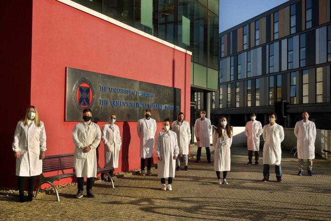 A group of researchers standing outside the QMRI building